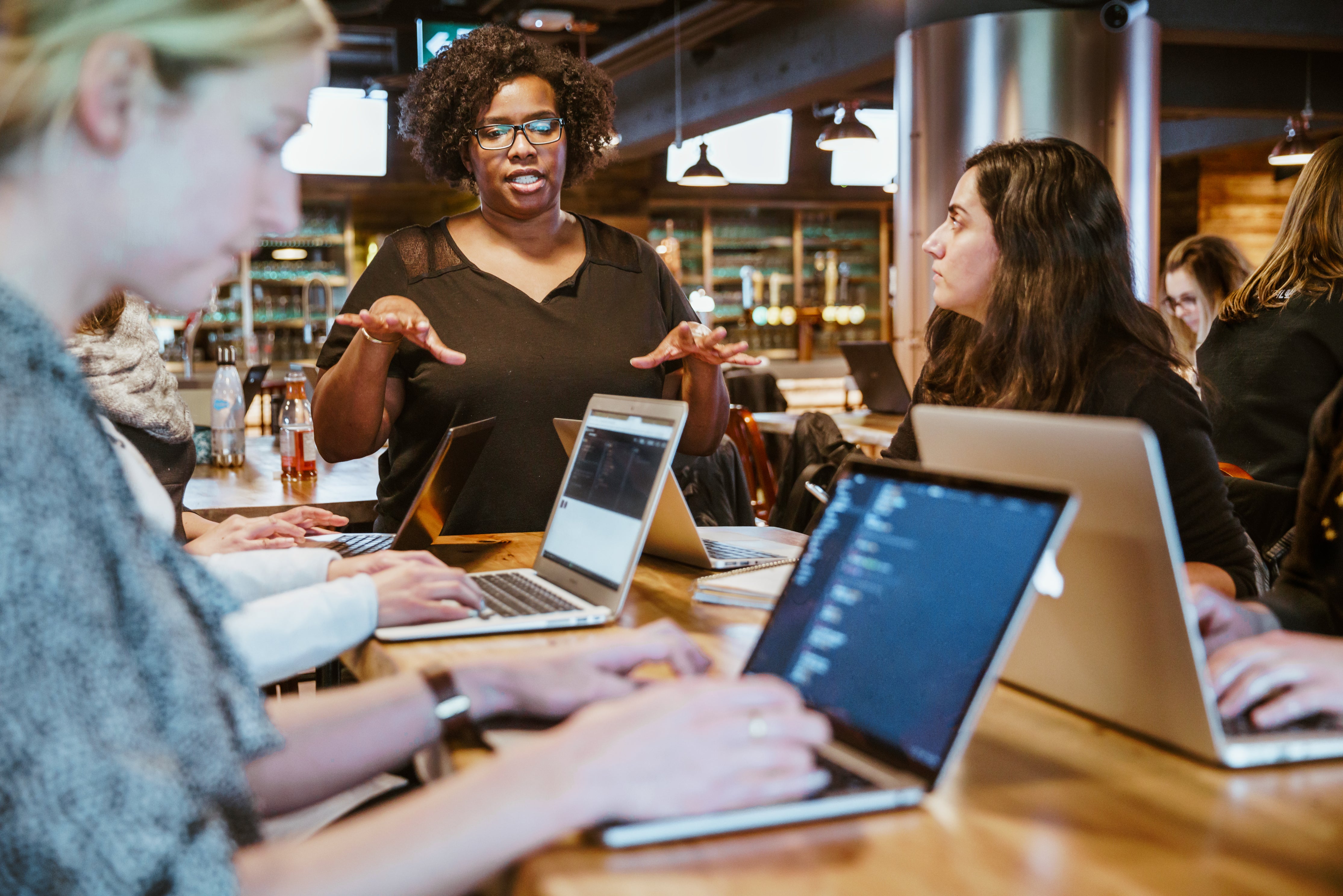 woman instructing on laptops